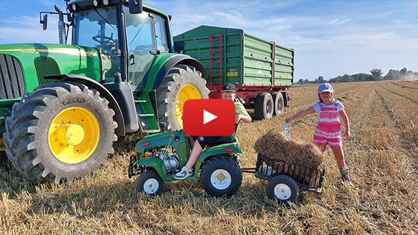 Children collect straw during harvest with a 110 mini tractor from Nitro Motors